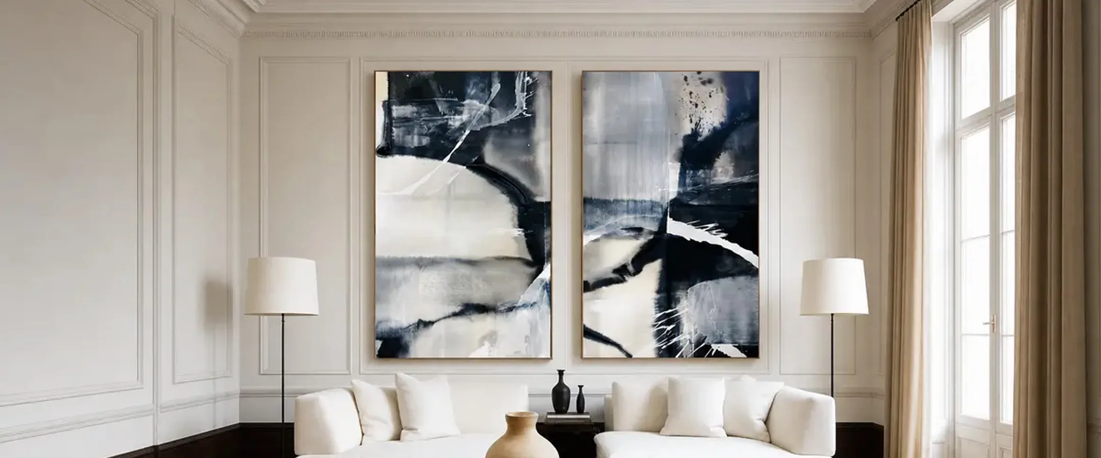 A two-panel black-and-cream Urban Collection painting by Erik Skoldberg hung above a sofa in a panelled room